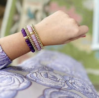 A beautiful stack of Palermo Bracelets in varying shades of purple by Caryn Lawn
