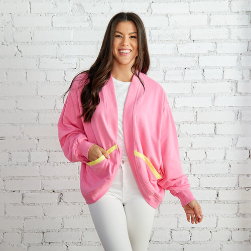 pink long sleeve sweater with yellow piped pockets